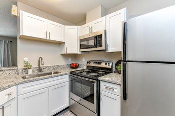 Kitchen with granite countertops and stainless steel appliances